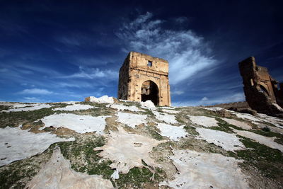 Low angle view of old ruin church against blue sky