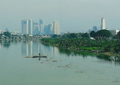 Scenic view of city by buildings against sky