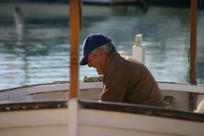 Side view of man looking at boat