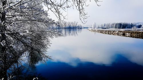 Scenic view of lake against sky during winter