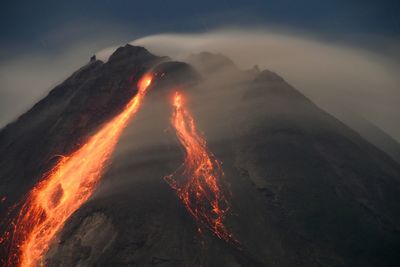 Panoramic view of illuminated mountain against sky