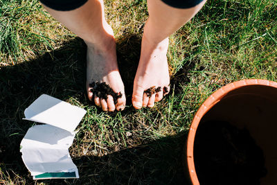 Girls feet covered in soil and seeds from planting in the garden