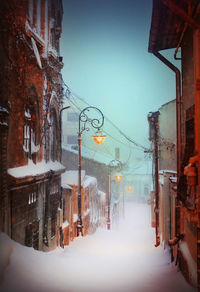 Buildings in city against clear sky during winter