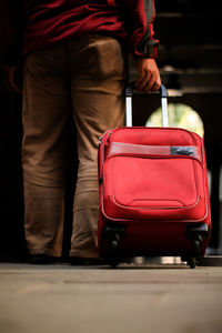 Low section of man standing on red floor
