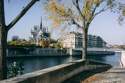 Bridge over river against buildings in city