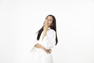 Woman standing against white background