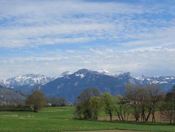 Scenic view of mountains against cloudy sky