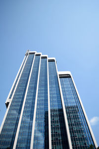 Low angle view of modern buildings against clear blue sky