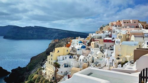 High angle view of townscape by sea against sky