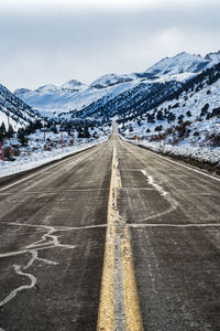 Winter road ascending into snowy mountain landscape
