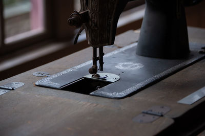 Close-up of sewing machine on table