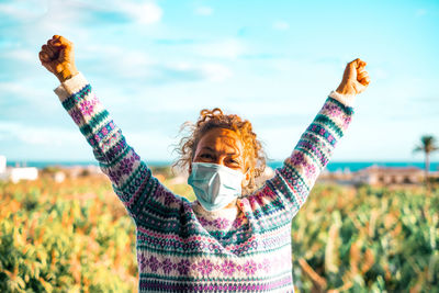 Midsection of woman standing against the sky