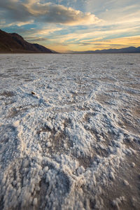 Scenic view of land during winter against sky