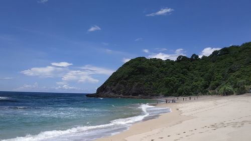 Scenic view of beach against blue sky