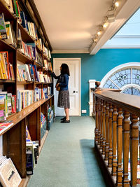 Daunt books shop in marylebone. woman looking for book. library with loads of books 