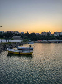 Boats in marina at sunset