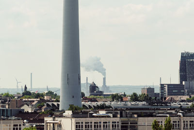 Industry and buildings against sky