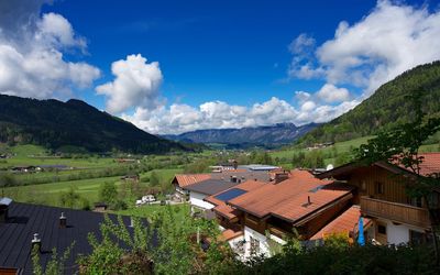 Scenic view of houses and mountains against sky