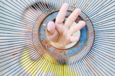 Close-up of hand on metal