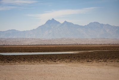 Empty road with mountain range in background