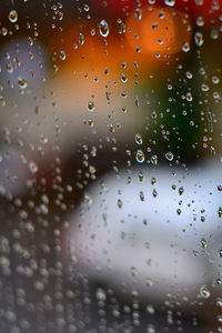 Full frame shot of wet glass window in rainy season