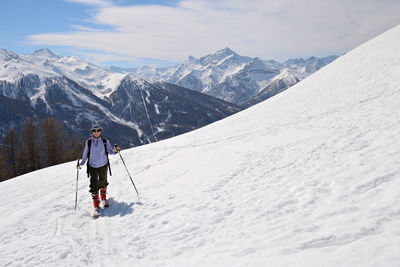 Full length of hiker on snowcapped mountain