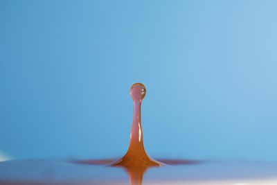 Close-up of water splashing against blue background