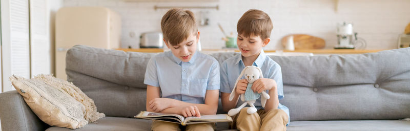 Teach your child to read book as teenager. caucasian child looking into book