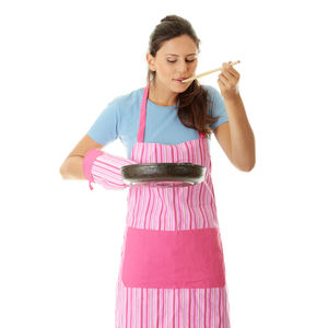 Young woman with arms raised standing against white background