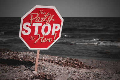 Close-up of warning sign on beach