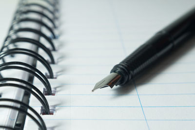 Close-up of pen on notepad