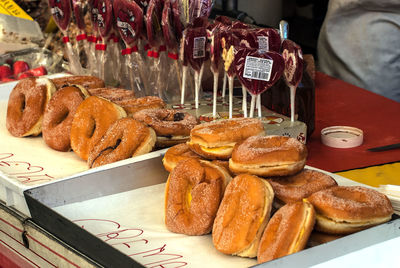 Close-up of baked buns and lollipops for sale