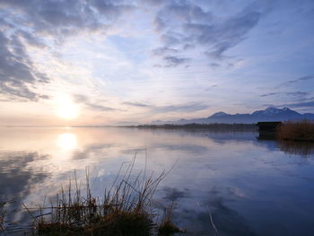 Scenic view of lake against sky during sunset