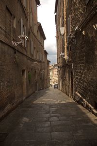 Narrow alley amidst buildings in city