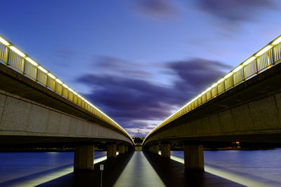 Illuminated elevated walkway at night