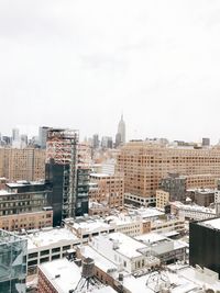 High angle view of buildings in city against sky