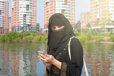 Rear view of woman standing in lake