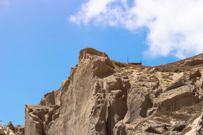 Low angle view of rock formation against sky