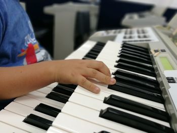 Close-up of boy playing piano