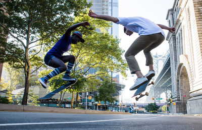 Low angle view of man skateboarding in city