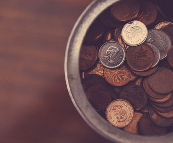 Cropped image of canadian pennies in container