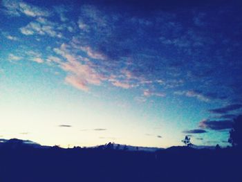 Silhouette landscape against sky during sunset