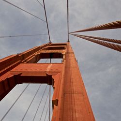 Low angle view of suspension bridge against sky