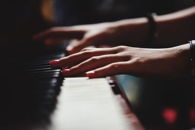 Close-up of hands playing the piano