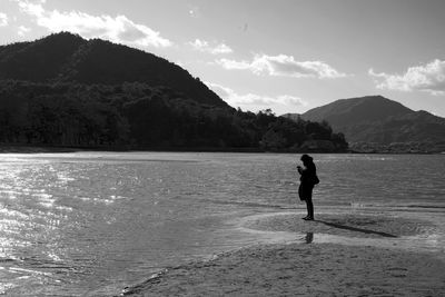 Man on beach against sky