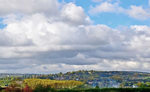 Scenic view of field against cloudy sky