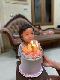 Portrait of smiling girl eating food on table