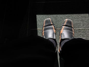 Low section of man standing on floor