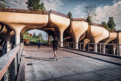 People walking in front of built structure