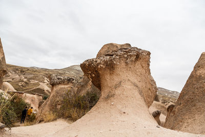 Low angle view of rock formations against sky